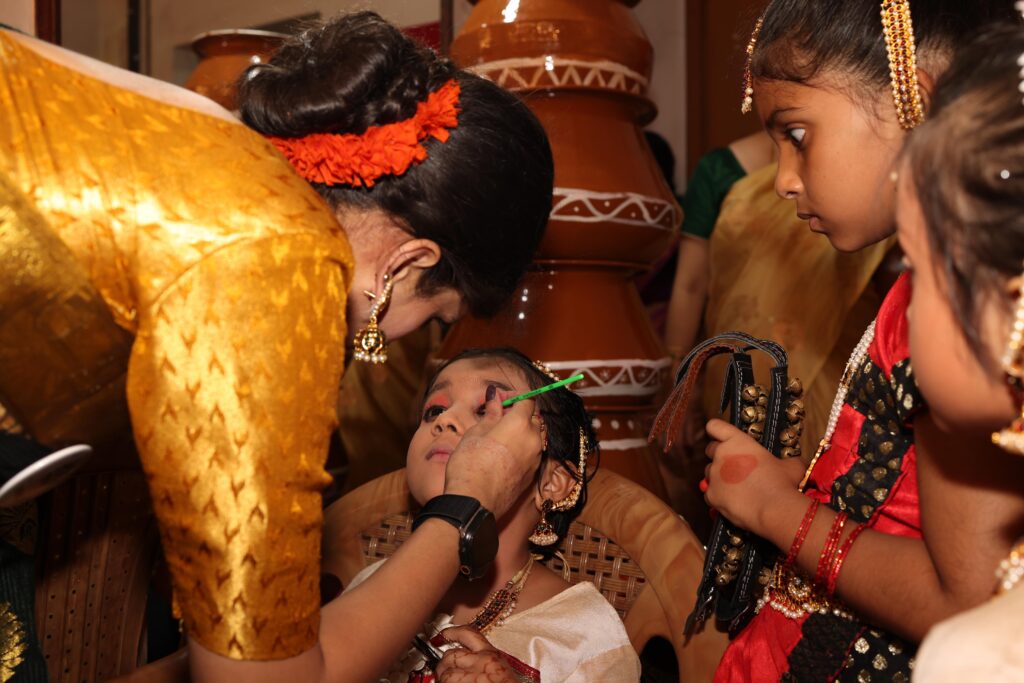 Vandya Mahesh doing makeup to young artists